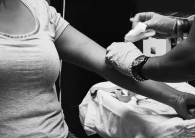 grayscale photo of man in t-shirt and watch holding smartphone