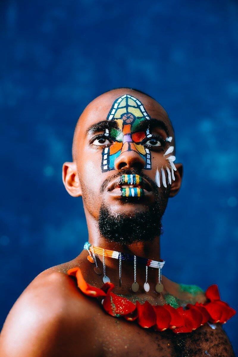 Photo by Njenga Jed man wearing red necklace