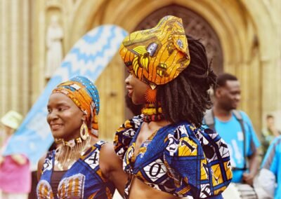 Dancers in blue and gold wax-print outfits near cathedral