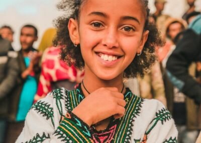 Young girl in traditional clothing smiles brightly